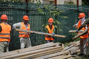 Indian construction workers safely working on a building project in Romania