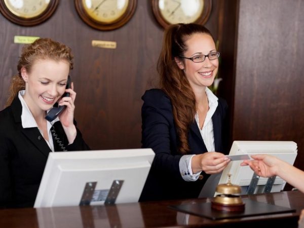 A diverse team of hotel staff providing excellent service in a Dubai hotel